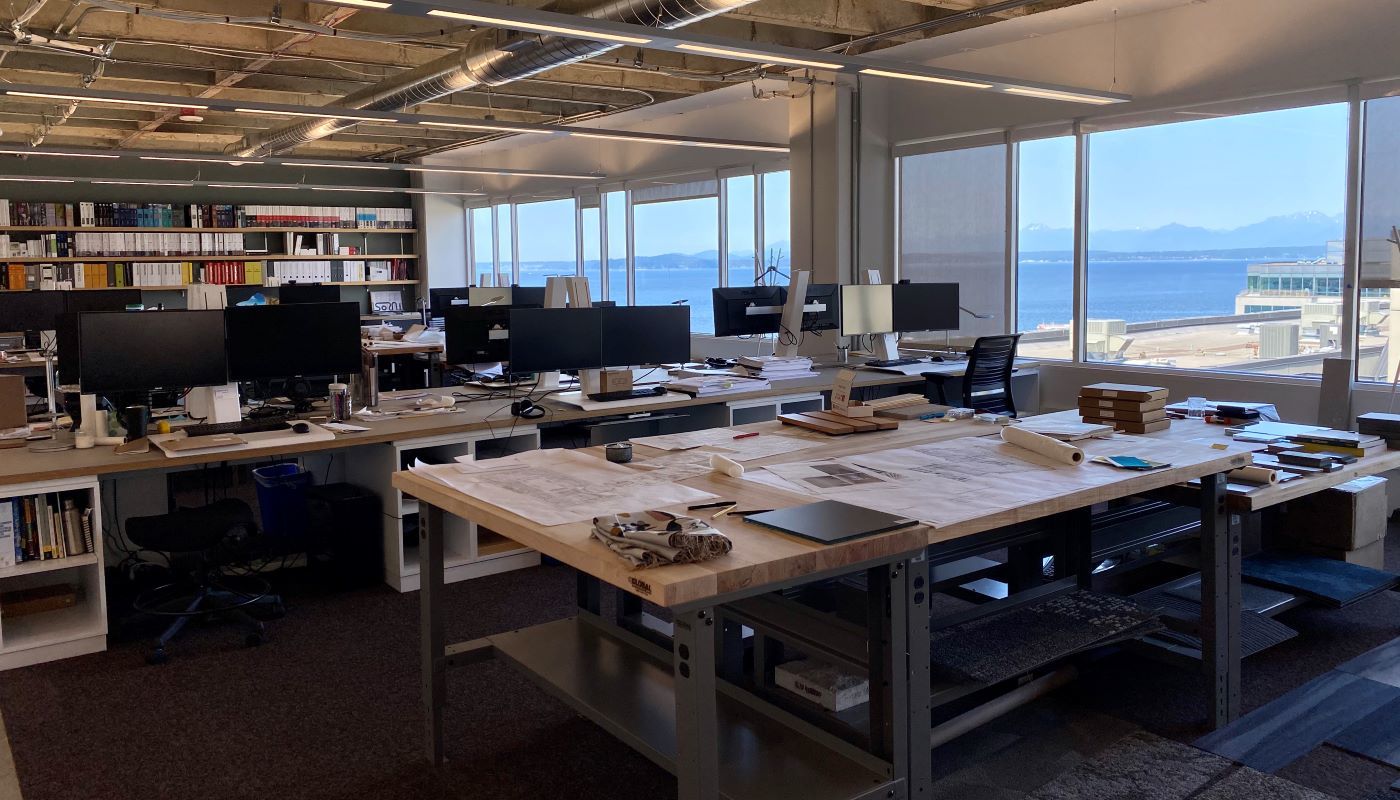 DPR Helps WRNS Studio Office Seek LBC Materials Petal Certification Interior workspace and desks at the WRNS Studio Office with views of Elliott Bay