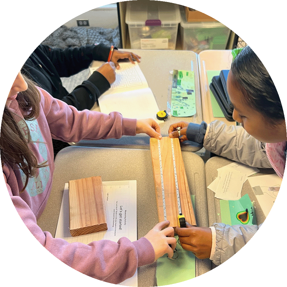 Children measuring a piece of wood in a classroom for Construction Inclusion Week